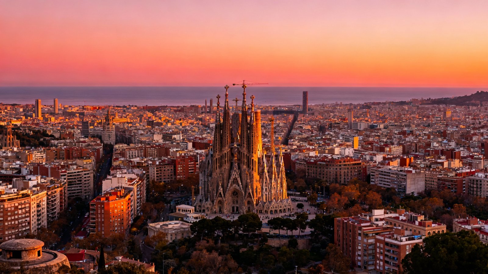 Breathtaking panoramic view of the Barcelona skyline at sunset from the Bunkers del Carmel, with sharp details and vivid colors
