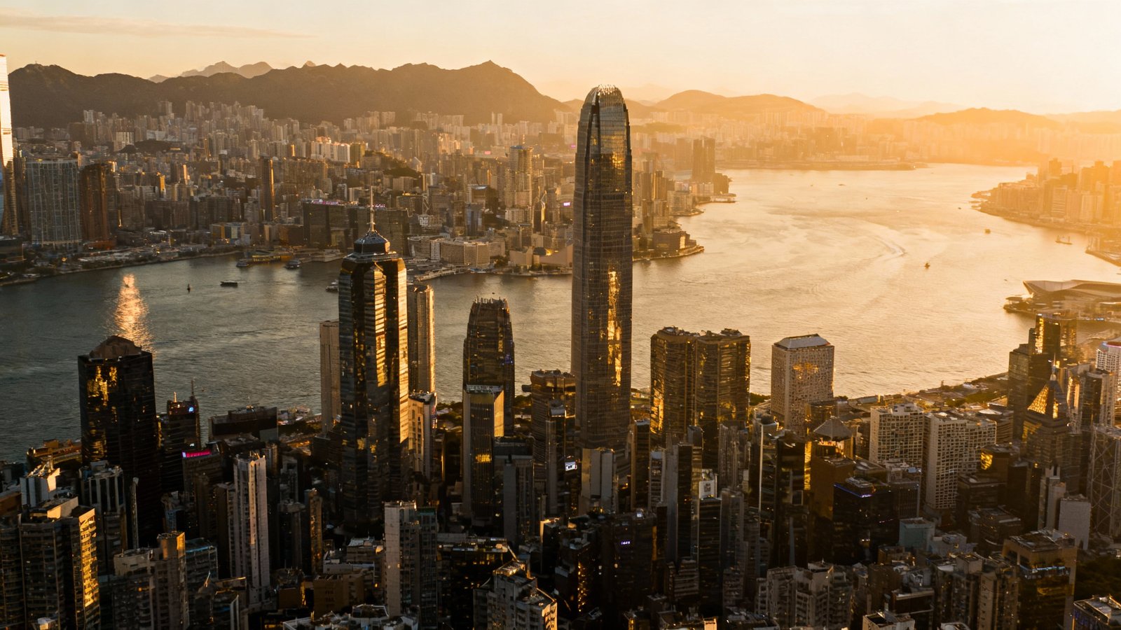 Ultra-realistic, cinematic wide-angle photo of the Hong Kong skyline as seen from Victoria Peak, with the city's skyscrapers and Victoria Harbour bathed in natural afternoon light