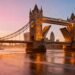 Cinematic wide-angle view of Tower Bridge at sunrise with the London skyline in the background